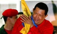Hugo Chávez hugs national flag while celebrating re-election in October