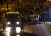 Demonstrators react to riot police during an anti-government protest in central Istanbul